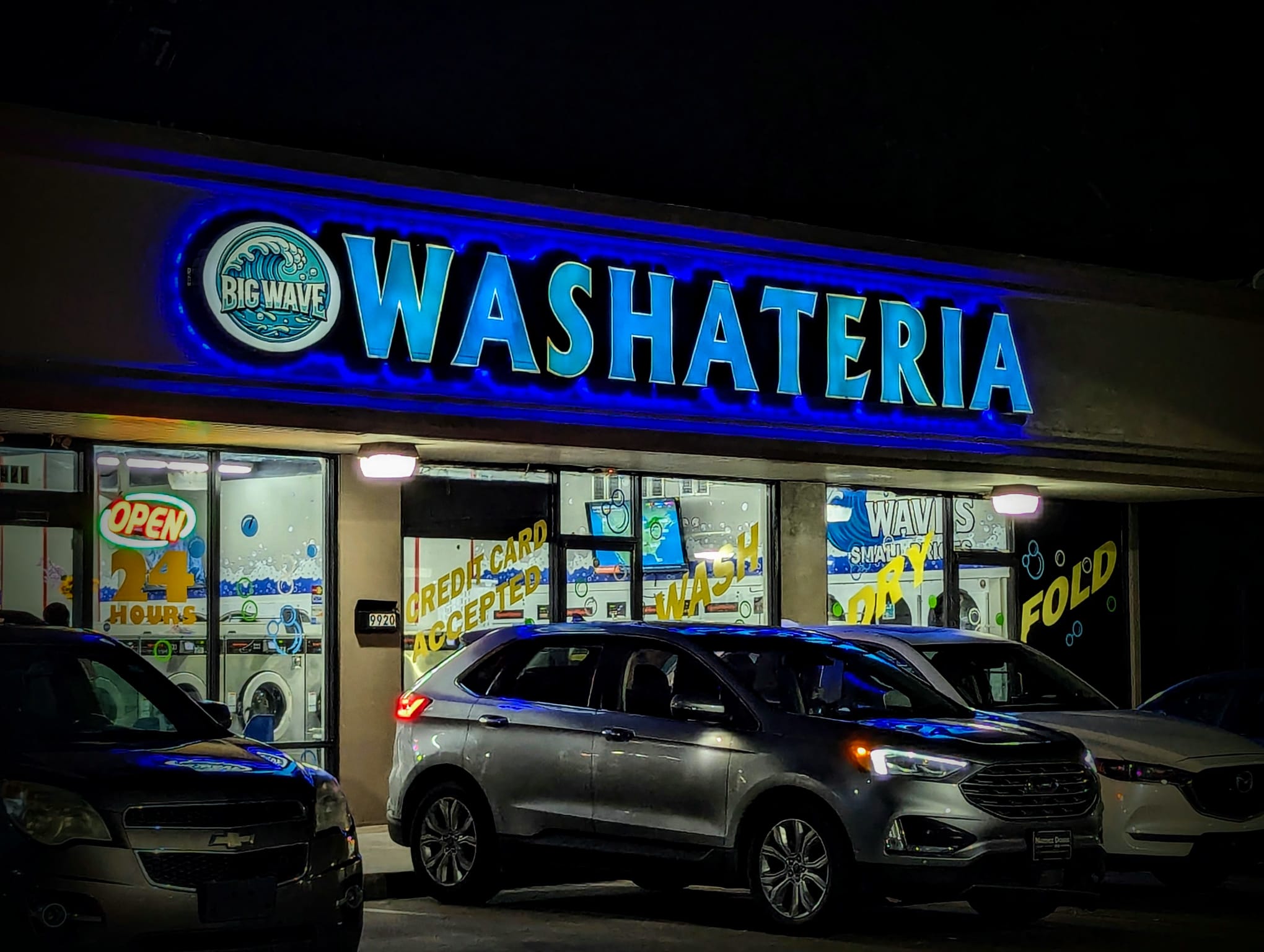 Big Wave Washateria at night — open 24/7 for drop-off